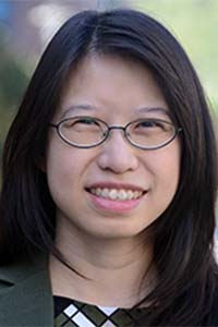 Photo of Vania Chan — woman with long dark hair wearing glasses. 